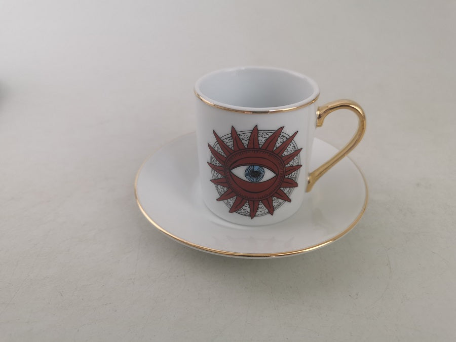 Tazzina per caffè tipo espresso con piattino, bordati in oro e decoro con sole e occhio centrale